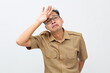 © ArvStd - Tired and stressed young indonesian government staff holding his head. Isolated on white