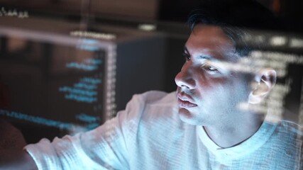 Man, programmer coding hologram at night doing data analytics, information technology malware or software . Male person, coder or developer working late in computer display in problem solving.
