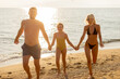 © BGStock72 - Family enjoys a joyful day at the beach during a sunny summer afternoon