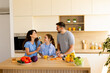 © BGStock72 - Family enjoys cooking together in a bright modern kitchen full of fresh produce