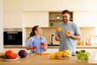 © BGStock72 - Father and daughter enjoy fun cooking time while juggling fresh produce