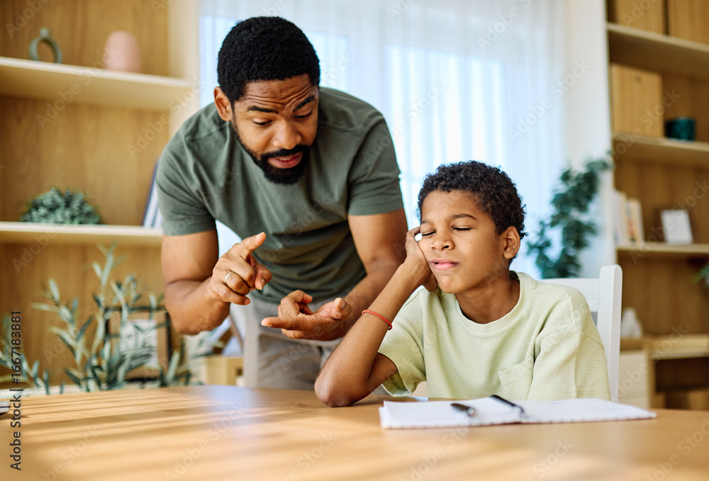 Father and son doing homework fighting and arguing over learning at ...
