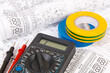 © bayurov - electrical engineering drawings, insulating tape and digital multimeter