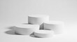 © Mirivox - Three white cylindrical platforms on a white background, showcasing a minimalist product display, ideal for clean and modern branding mockups