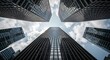© Darmanto - Low angle shot of modern skyscrapers reaching towards a cloudy sky, symbolizing ambition and urban growth