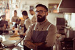 © Davor - Portrait of a confident chef standing with arms crossed in professional restaurant kitchen