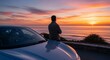 © Ilham - Man admire scenic ocean sunset next to car travel and exploration
