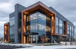 © john - Modern commercial building featuring glass facade wih wood accents, metal panes. Structure offers clean,pro design with large windws reflecting cloudy blue ky. Ideal for business, coporate,