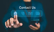 © Nirusmee - Contact us or Customer support hotline, Businessman touching on virtual screen contact icons (email, address, live chat, telephone). Customer service, helpdesk advice online support people connect.