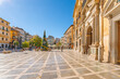 Christmas and holiday decorations go up at Plaza de Santa Ana near the High Court of Justice building on a sunny day in the Andalusian city of Granada, Spain. 