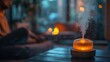 © photolas - Relaxation space featuring aromatherapy diffuser with mist and a figure in a tranquil pose by a warm fireplace