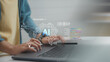 © CL STOCK - Hands typing on laptop with AI virtual interface icons. Concept of generative AI, artificial intelligence innovation, machine learning, digital transformation, and future smart technology in business.