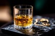 © Jane_S - Close-up of whiskey glass on marble surface with gold bracelet