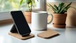 © Sidra - Smartphone on a stand with plants and a mug on a bright windowsill