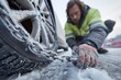 © Ulivers - Man attaching snow chains to icy car wheel, cinematic winter roadside scene perfect for safety instructions, transport campaigns, or articles