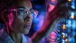 © AounMuhammad - A focused Black woman in glasses adjusts a network server, illuminated by colorful LED lights.