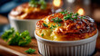 © Aliaksandra - Golden cheese souffle baked in a white ramekin, garnished with fresh parsley on a rustic wooden board