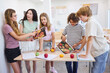 © Robert Kneschke - Teenagers discussing nutrition and healthy foods in a school classroom setting