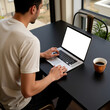 © Родион Бондаренко - young man sitting at table with laptop and cup of coffee, top view, laptop monitor mockup
