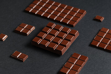 Wall Mural - Composition with tasty chocolate bars on dark background