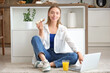 © Pixel-Shot - Young happy woman holding laptop, glass of juice and tasty toast with fresh butter in kitchen at home