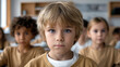 © visoot - Serious boy blue eyes blond hair classroom children learning education focused school group