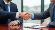 © Margarita Ratatosk - Two men shaking hands during a business meeting, signifying a successful deal closure. Agreement concept for finance.