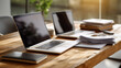 © Nataliya - Laptops and papers on a table, the organized scene illuminated by soft sunlight. Laptops, table, with copy space