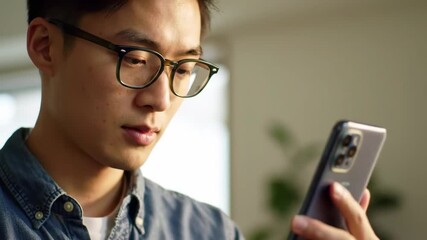 Focused Young Man Using Smartphone