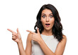 © MdMashud - Surprised woman points left and right with wide eyes and open mouth expressing astonishment transparent background