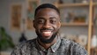 © Johannes - smiling cheerful young adult african american ethnicity man looking at camera standing at home office background happy confident black guy posing for headshot face front close up portrait no logos no