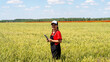 © Barillo_Images - Sustainable farming concept with modern female farmer inspecting grain crops in growth phase using digital tablet