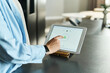 © pressmaster - Caucasian young adult woman using digital tablet with security lock icon on screen, touching display while standing at kitchen counter, focusing on technology and data protection
