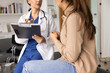 © fizkes - Serious female physician giving consultation to young patient woman