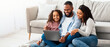 © Prostock-studio - Family Weekend. Cheerful African American parents and their little daughter using laptop at home together, watching movie or browsing internet, sitting on the floor carpet in living room