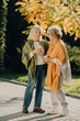 © dsheremeta - Two senior women smiling and holding coffee cups in autumn park