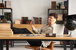 © Pixel-Shot - Male teacher with bribe talking by mobile phone in classroom. Corruption concept