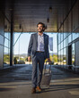© Miljan Živković - Businessman walking with suitcase at airport terminal
