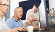 © JackF - Focus on senior man who is learning to work on computer in a group of elderly people