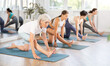 © JackF - Elderly woman doing pilates exercises in group in fitness studio