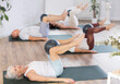 © JackF - Active senior women doing pilates with soft ball lying on back in gym