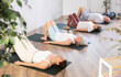 © JackF - Group of women doing different yoga exercises lying on their back