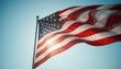 © Pixel_Studio - American flag waving against clear blue sky united states