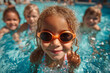 © john - A group of diverse young children enjoying swimming essons in pool, learning wter safety skills and havig summer fun
