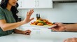 © Meow Creations - Young woman declining unhealthy fast food plate for a healthy lifestyle choice