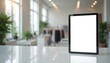 © Viktor - White tablet with blank white screen rests on white desk in blurred fashion store interior. Modern device displays clean white screen, perfect for mockups, digital fashion, online retail promotions.