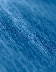 Close-up of a textured, blue, fibrous surface with diagonal lines