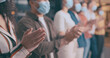 © peopleimages.com - Applause, face mask and hands of business people in office for achievement, motivation or success. Celebration, crowd and support with employee team in PPE, clapping for bonus, goals or target