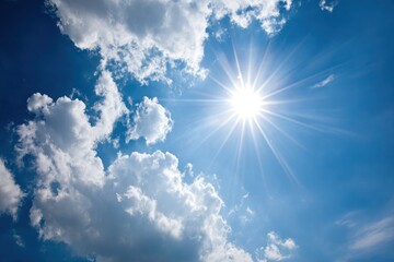 bright sun bursts through a blue sky with fluffy white clouds. warmth and hope emanate from the scen