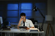 © Stella 16 - Business, night and man with stress, headache and burnout with new project, deadline and tired. Male person, employee and consultant with a migraine, pain and overworked and professional working late